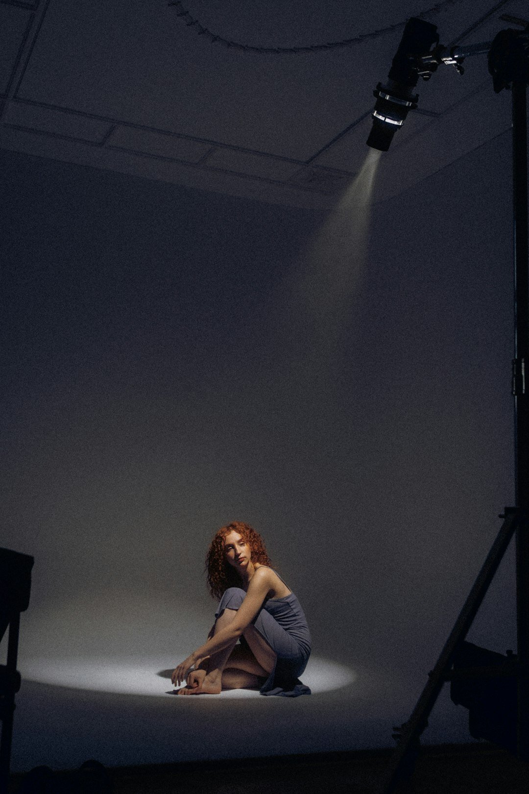 Camera crew filming a seated interview under studio lights