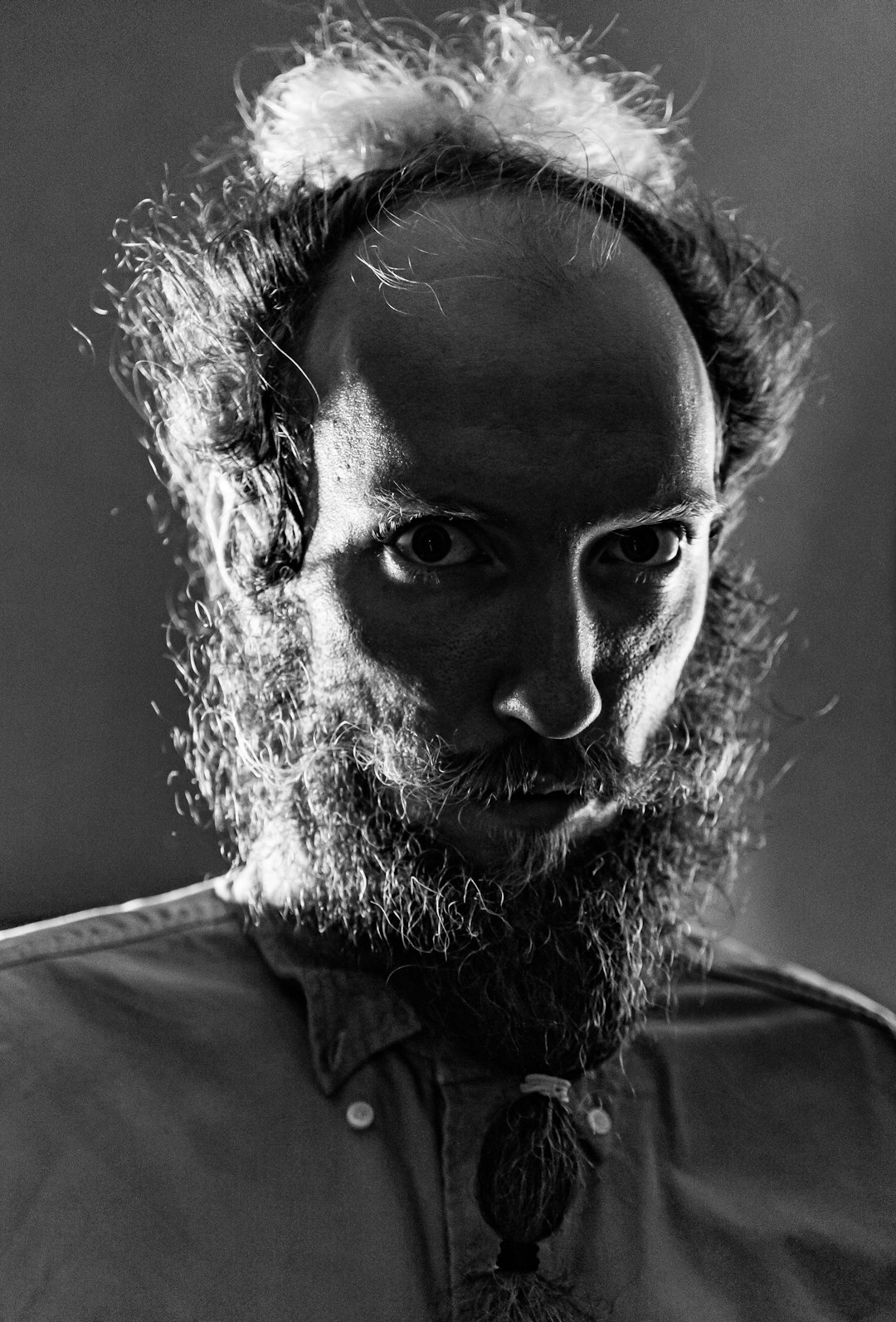 Studio portrait of a European documentary maker with a beard